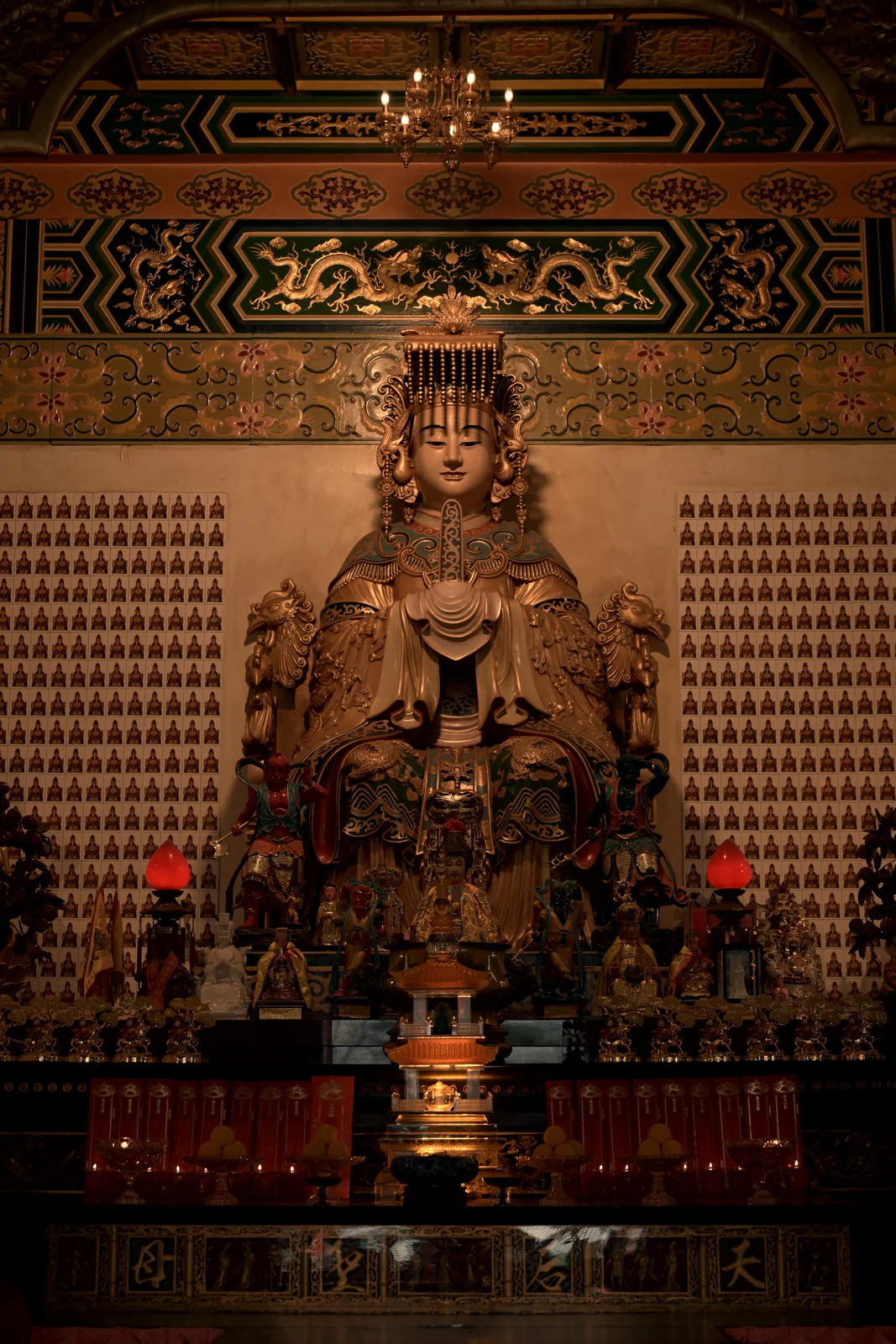 Intricate traditional wood carving and warm incense glow in Thean Hou Temple