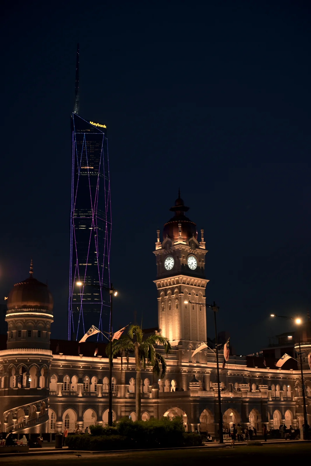 Sultan Abdul Samad Building illuminated across Merdeka Square at night