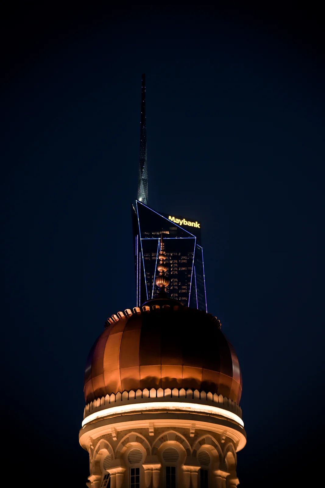 Copper onion dome of Sultan Abdul Samad Building glowing warmly at night