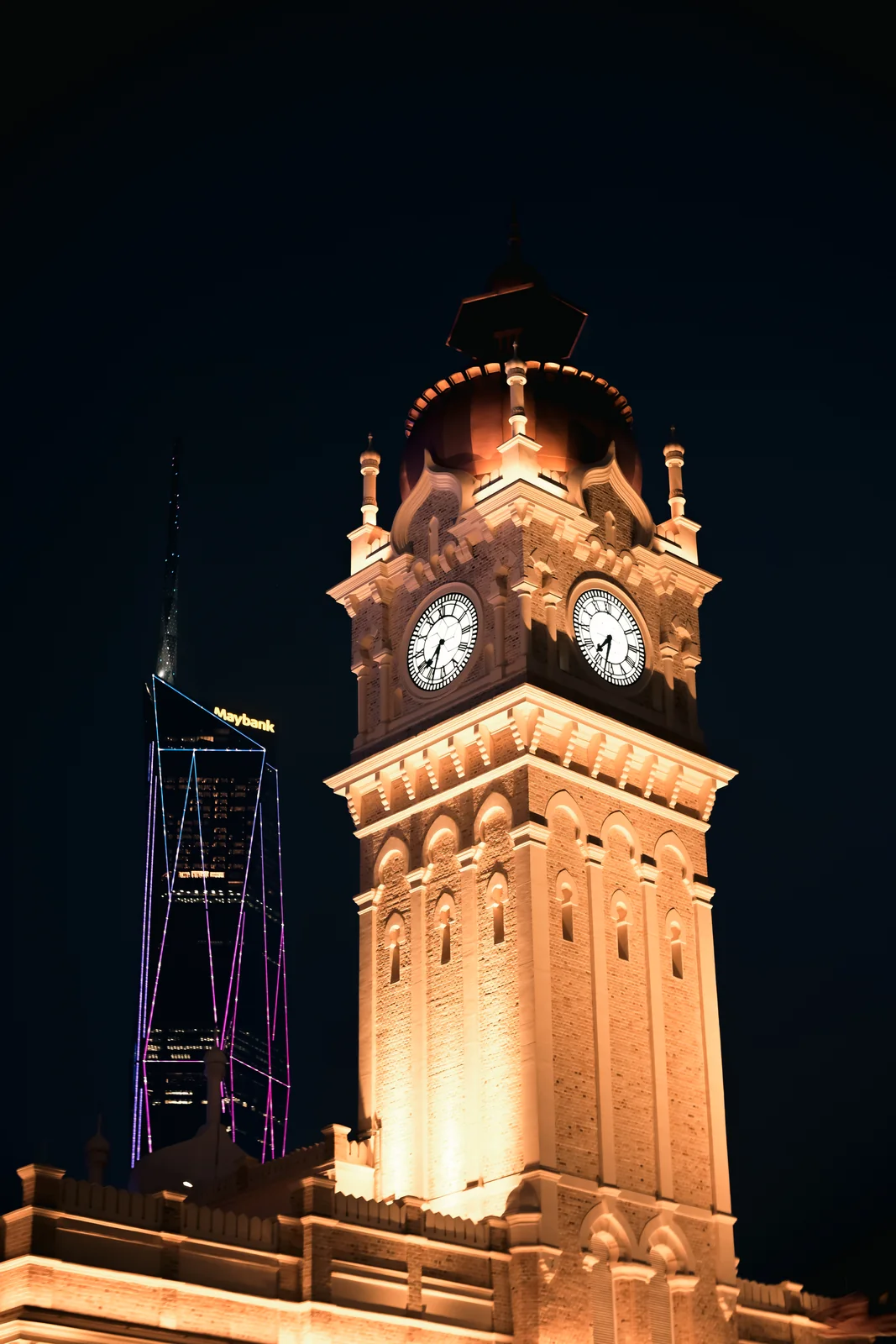 Colonial clock tower spire glowing with golden architectural lights