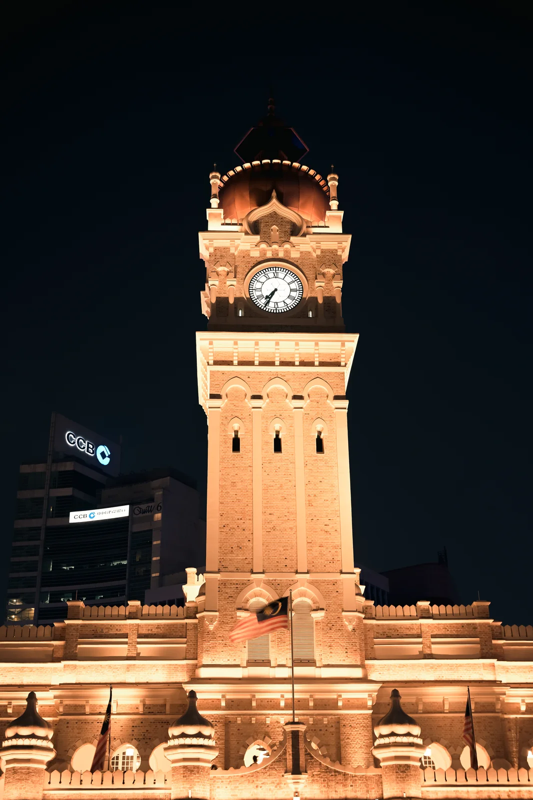 Clock tower face close-up illuminated against the night sky