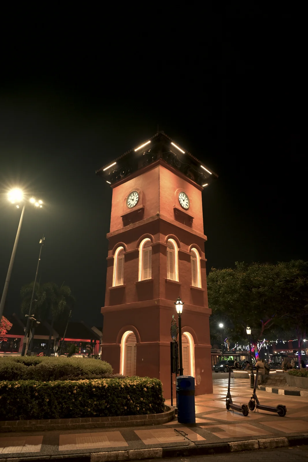 Melaka Red Square clock tower illuminated in the dark night