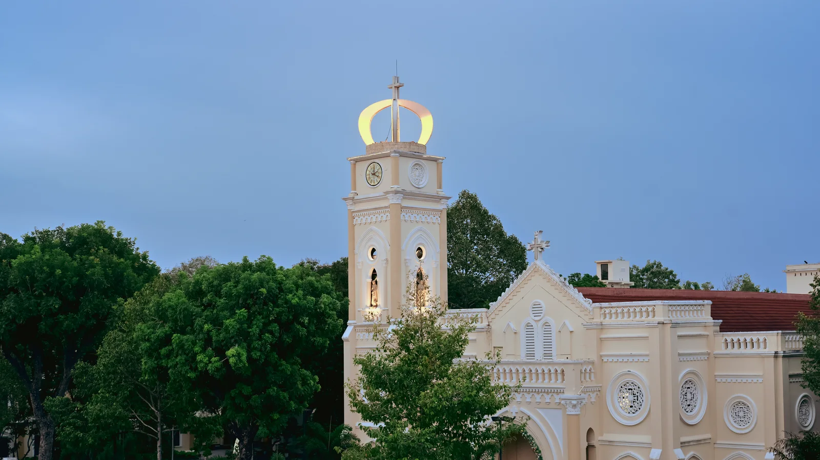 Nhà thờ Chánh tòa Mỹ Tho with illuminated golden crown atop bell tower at dusk