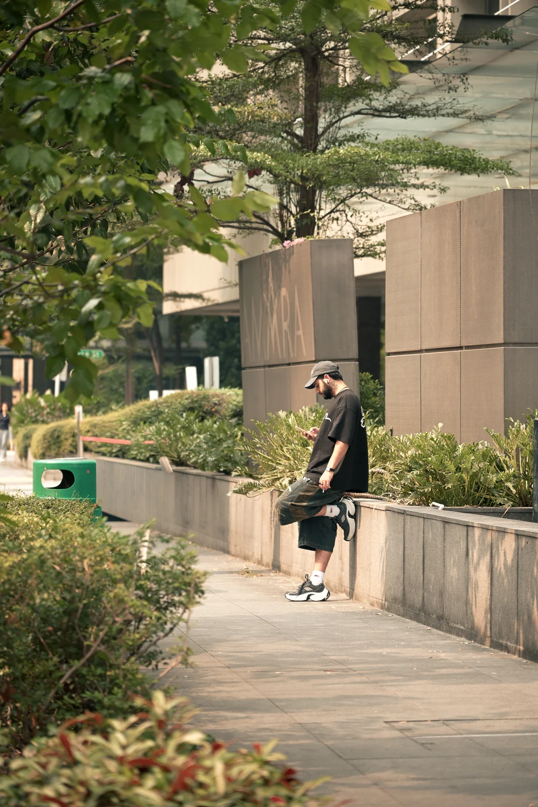 Greenery pathway flanked by modern urban architecture