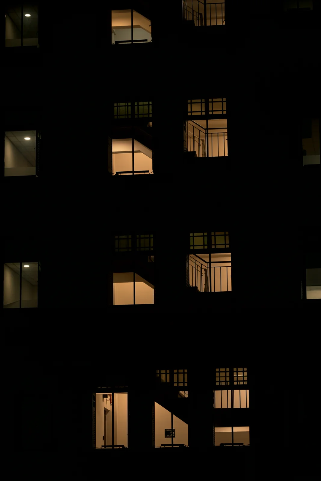Geometric illuminated windows of modern Singapore high-rise at night