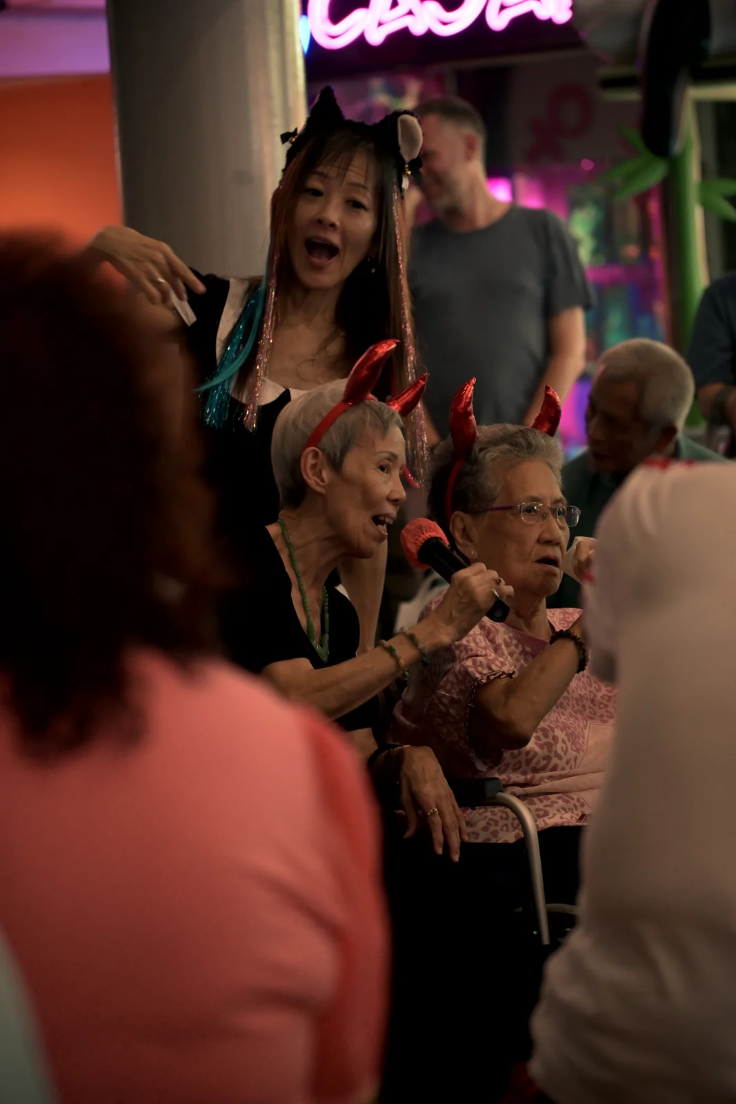 Lively crowd singing along at vibrant evening night market gathering