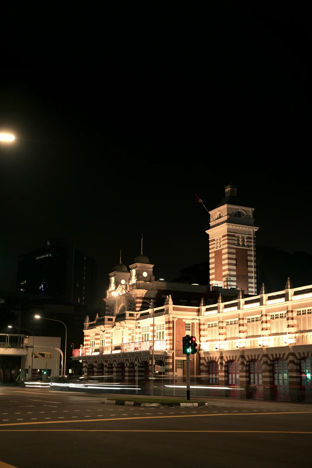 Victoria Theatre and Concert Hall clock tower illuminated against dark sky
