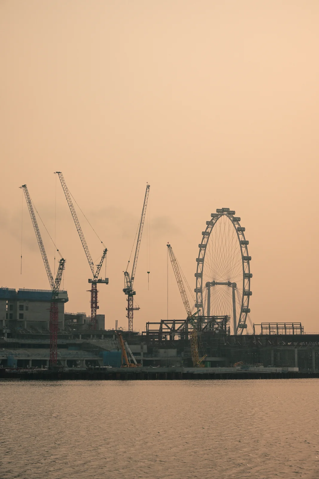 Singapore Flyer observation wheel and skyline silhouettes at twilight