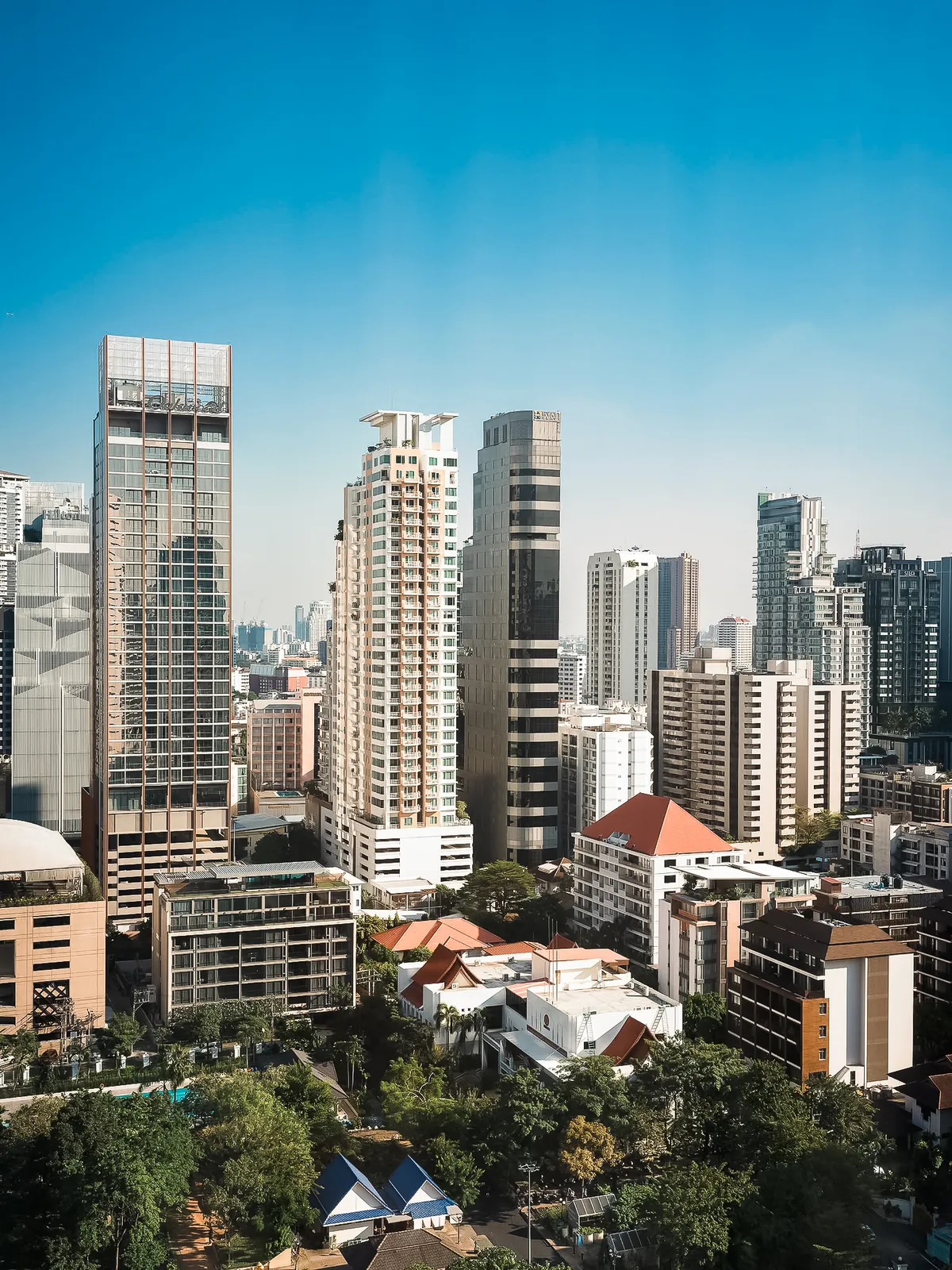 Bangkok city skyline overlooking modern skyscrapers and lush urban greenery