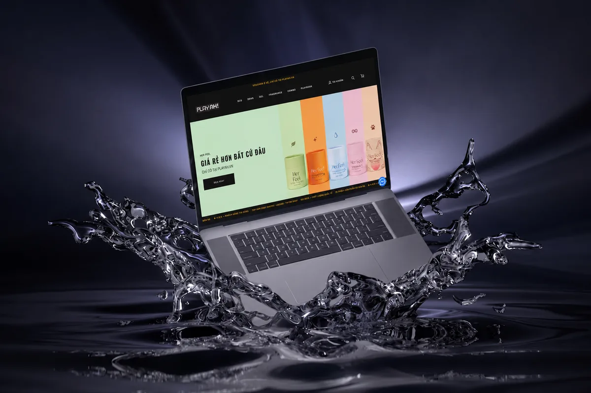 PlayAh! website shown on a laptop with water splash styling
